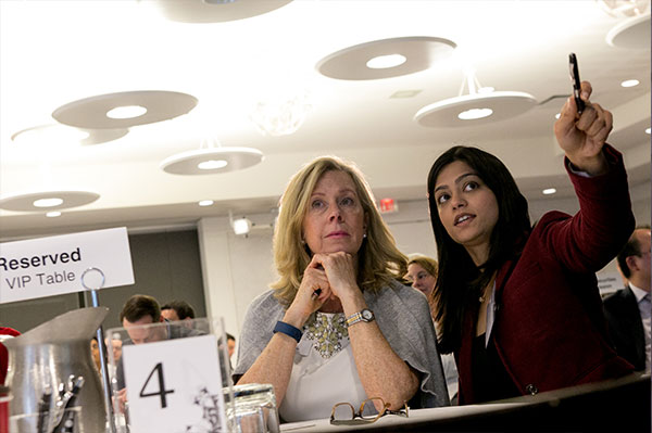 Two women speaking to each other at an event