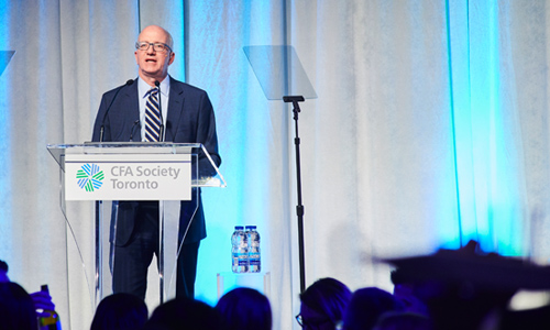 Man speaking at podium with CFA logo